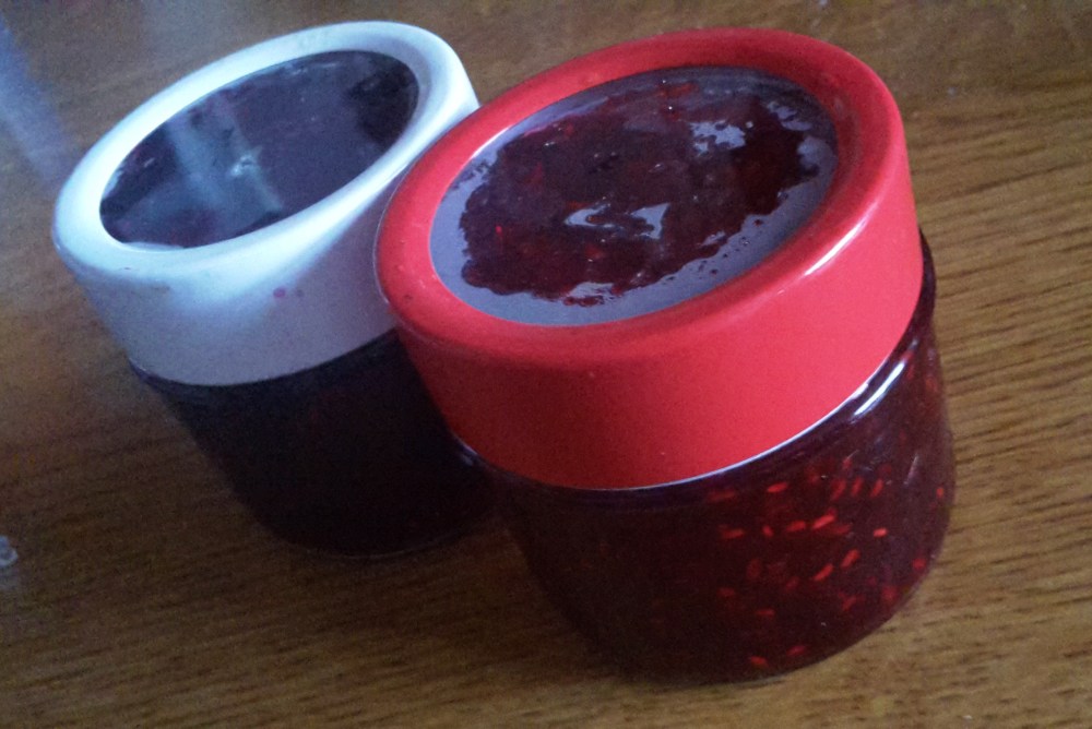 Two jars of homemade blackberry and raspberry jam