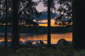 Camping next to a lake at sunset